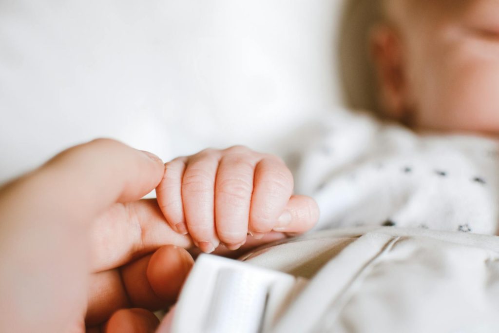 Divorced mother  holding baby's hand