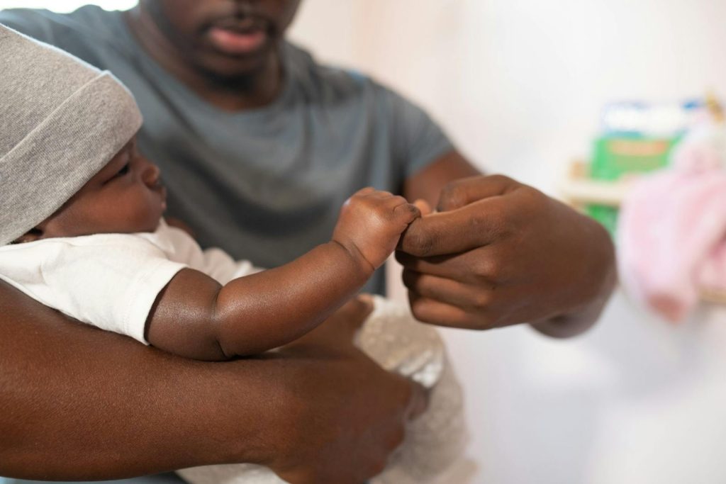 Man holding and playing with his baby