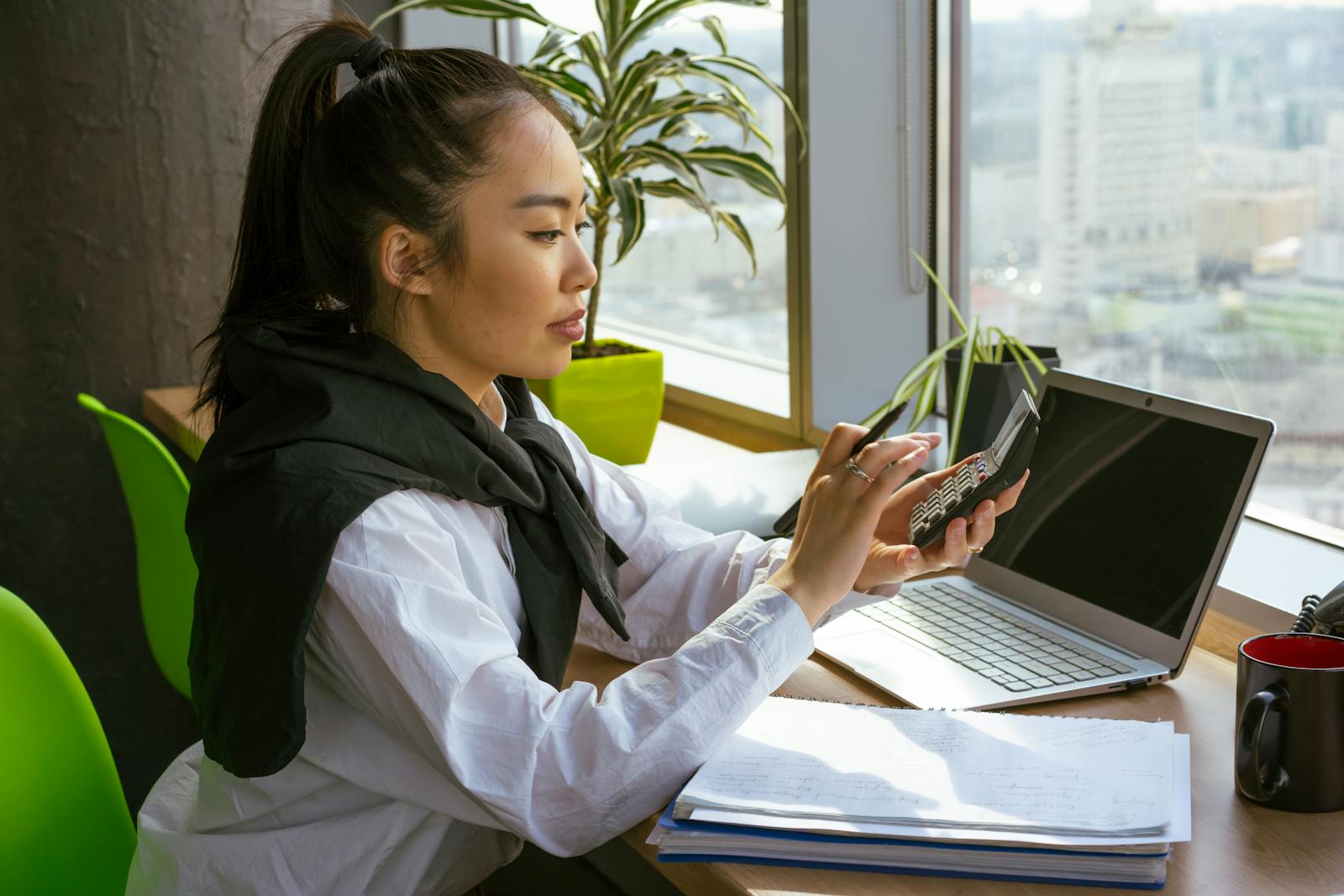 Woman calculating alimony using calculator