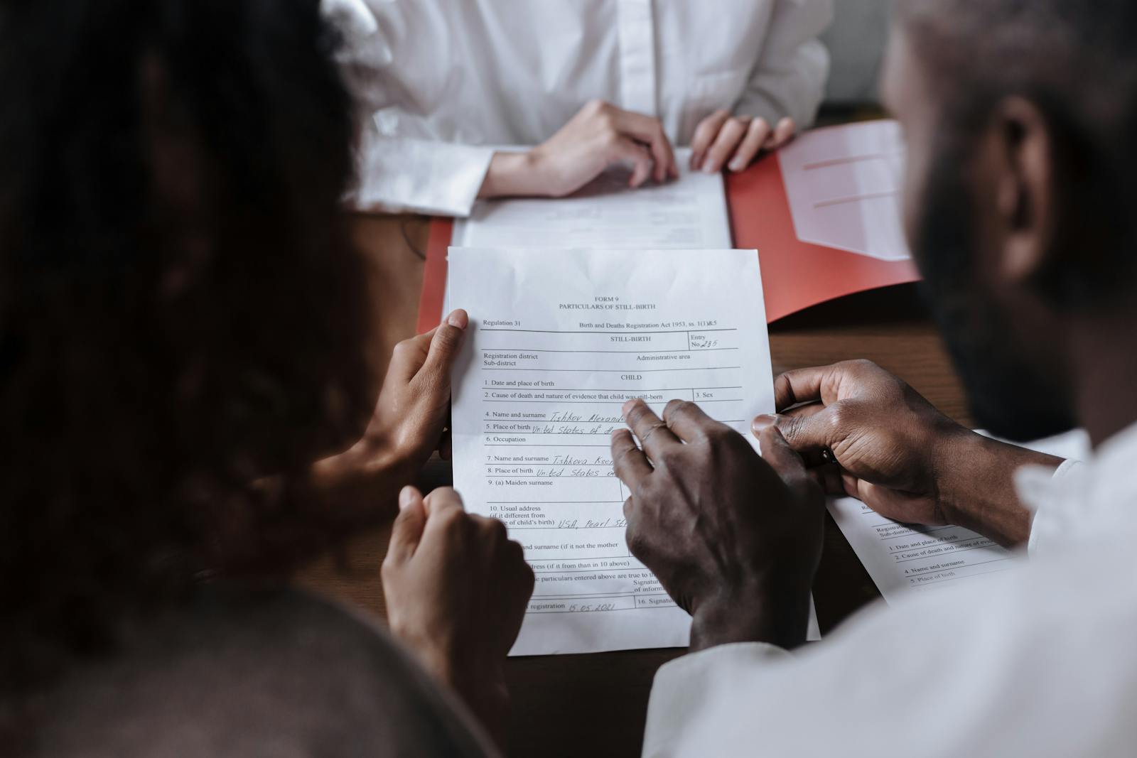 Couple looking through legal documents in a midiator's office